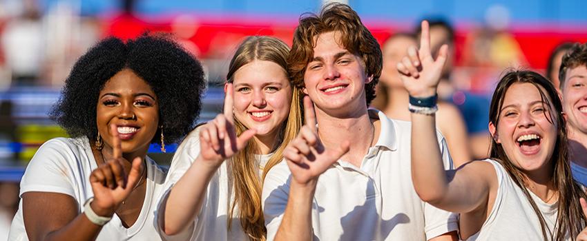 Students holding up J hand for Jaguars.